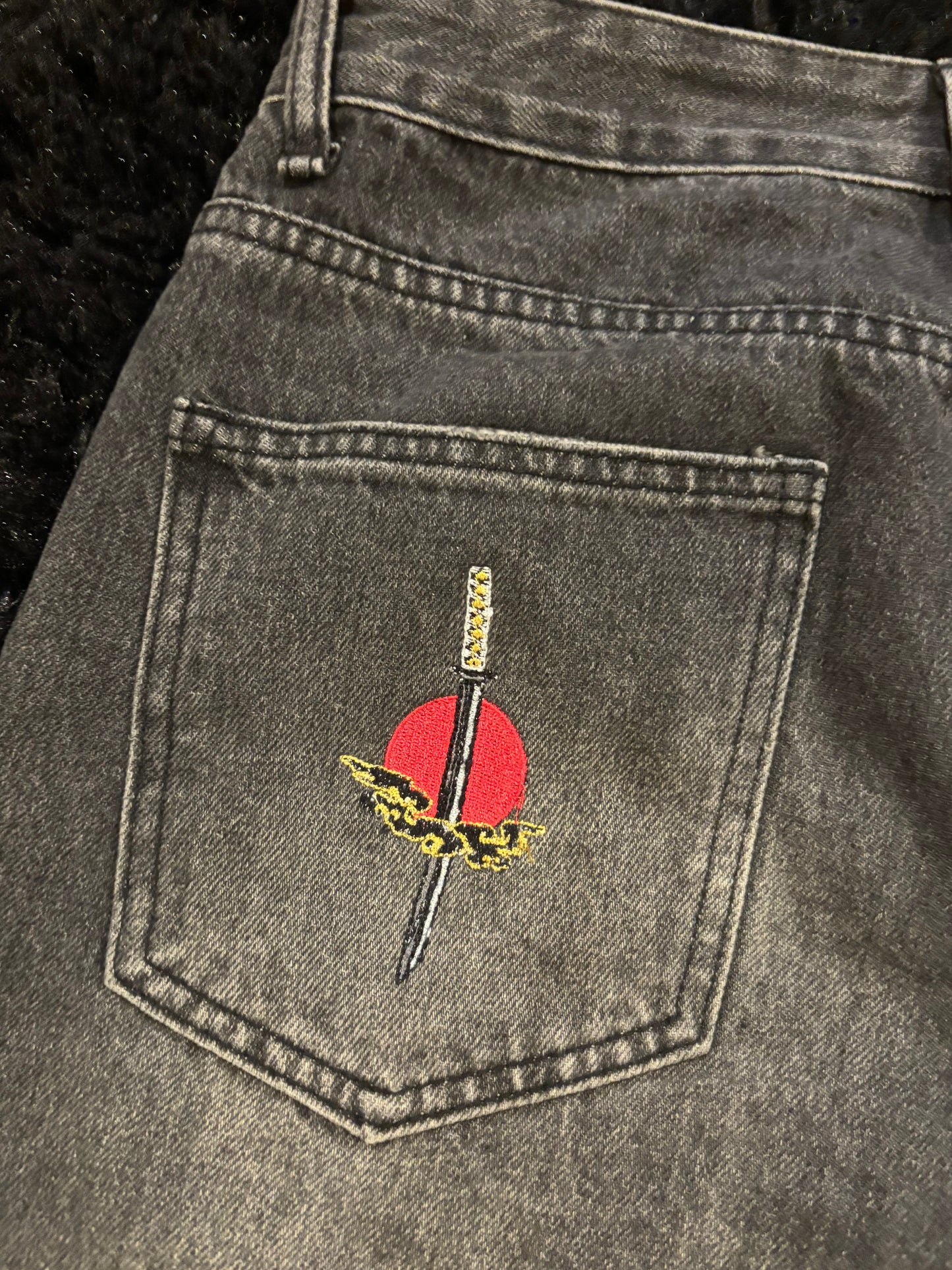 Baggy black embroidered jeans.