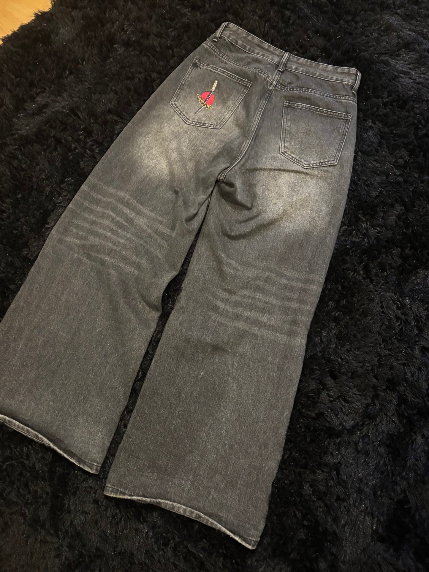 Baggy black embroidered jeans.