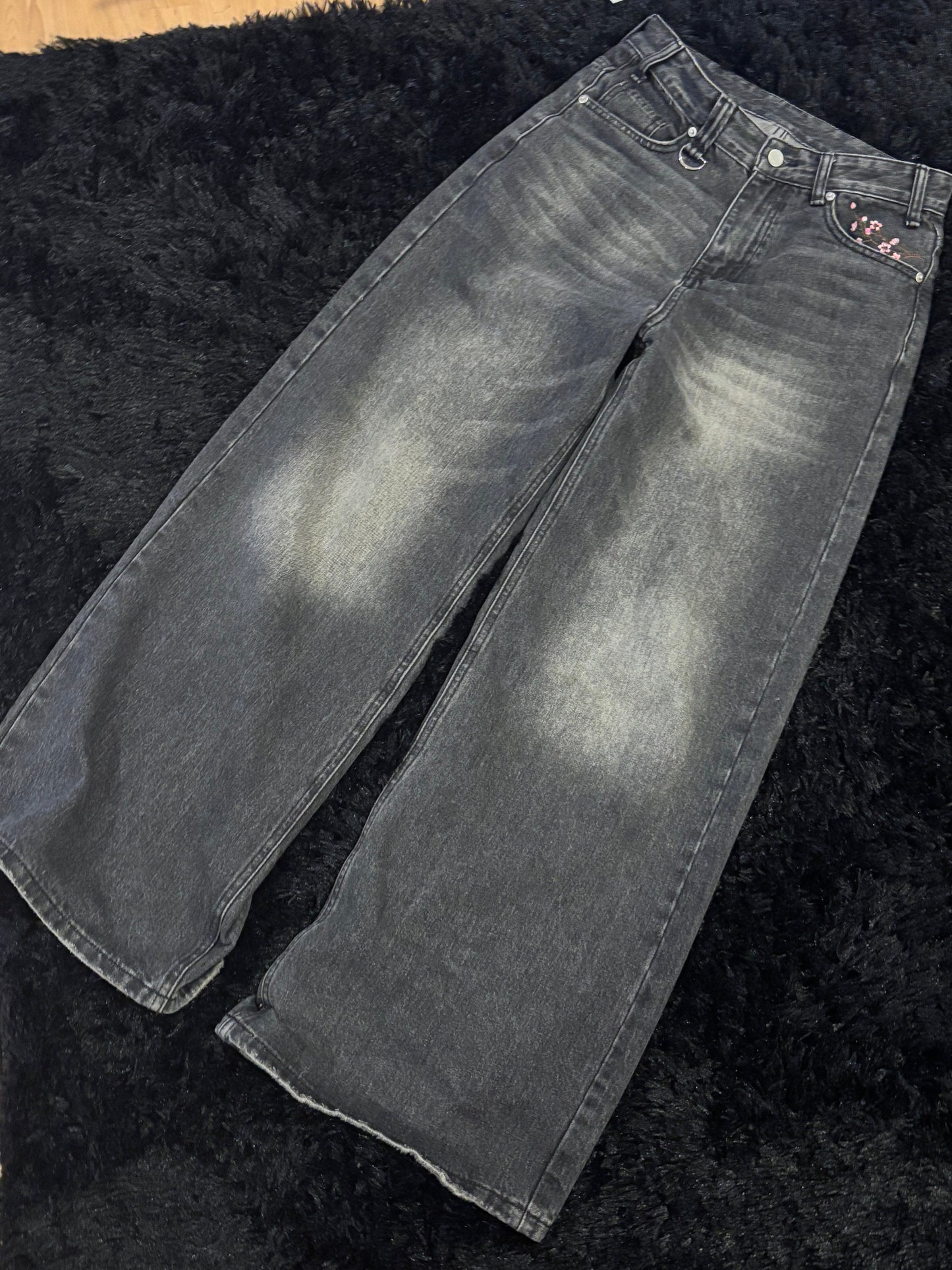 Baggy black embroidered jeans.