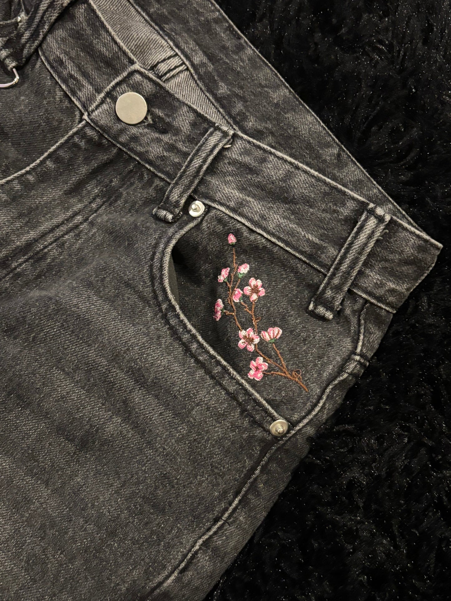 Baggy black embroidered jeans.