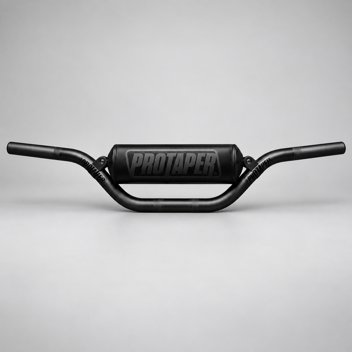 Black ProTaper handlebars with crossbar pad on a clean light gray studio background